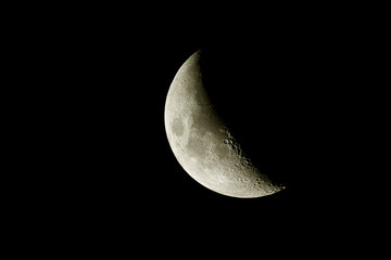 Naklejka premium Waxing crescent moon as background