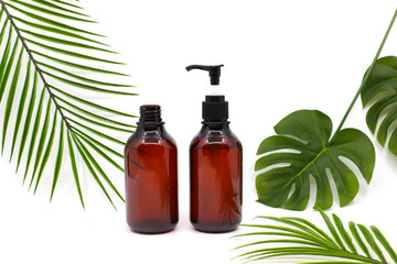 bottle of essential oil with green leaf