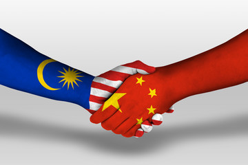 Handshake between china and malaysia flags painted on hands, illustration with clipping path.