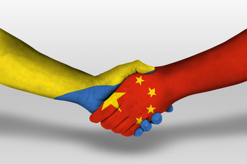 Handshake between china and ukraine flags painted on hands, illustration with clipping path.