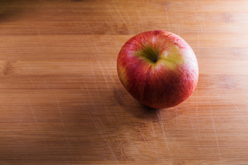 red apple on a wooden table