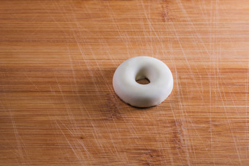 Fototapeta na wymiar small white chocolate donut on a wooden table