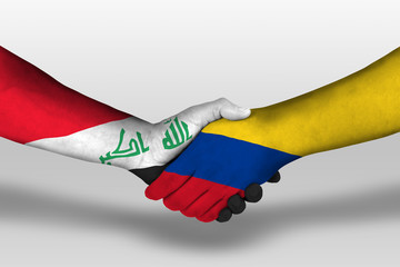 Handshake between columbia and iraq flags painted on hands, illustration with clipping path.