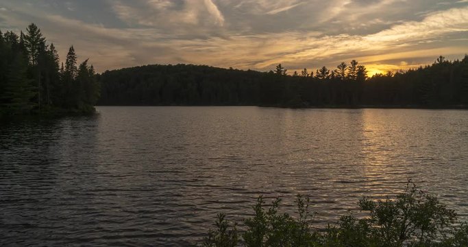 Algonquin Provincial Park Ontario Canada. Sunset time lapse over Sproule Lake. Includes 4 versions - 1 stationary, 1 tilt up, 1 pan right, 1 cropped in to 100%.