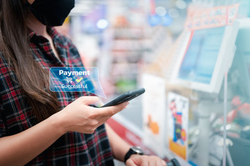 Woman using mobile smart phone, online payment, banking and online shopping in the shopping mall.