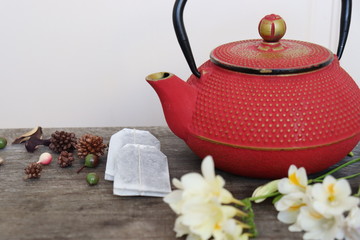 Red teapot in a retro setting.