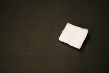One cotton pad isolated on black background