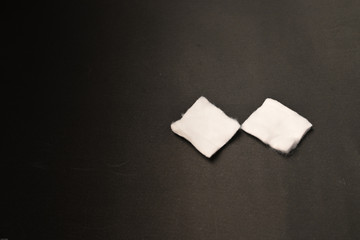 Two cotton pads isolated on black background