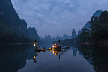 Chinese traditional living habits, images of traveling in Guilin, China, a fisherman relaxing on the Li River.