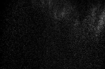 Obraz premium Abstract splashes of water on black background. Freeze motion of white particles. Rain, snow overlay texture.