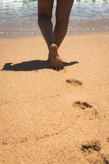 Woman leaving her footprints in the sand