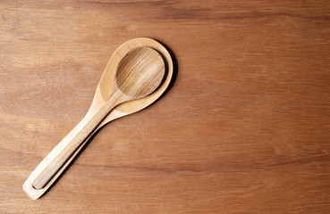 Wooden spoon on wooden background.