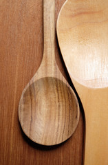 Wooden spoon on wooden background.