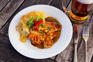 Chicken slices with baked potato under gravy - Czech cuisine