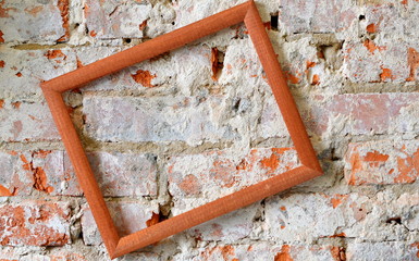Wooden picture frame. Picture frame on a brick wall.