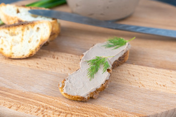 Fresh homemade chicken liver pate on wooden board