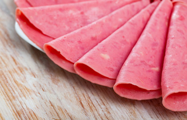Appetizing boiled sausage mortadella from turkey on wooden table © JackF