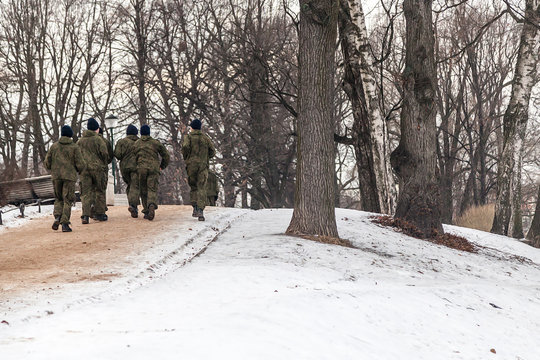 Russian cadets of the military school running in the winter park