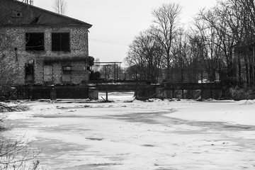Abandoned brick pier on the river in front of the ice drift