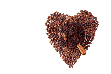 Homemade scrub with ground natural coffee on heart-shaped coffee beans