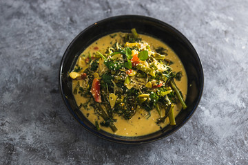 plant-based food,  vegan green curry with spinach broccolini kale and stir fry vegetables