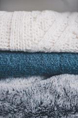 Fototapeta na wymiar winter lifestyle concept, soft and fluffy blankets and throws stack