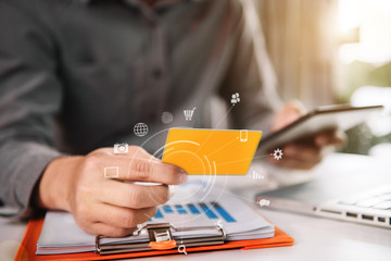 Businessman hold credit cards, conduct financial transactions via tablets and data documents, put...