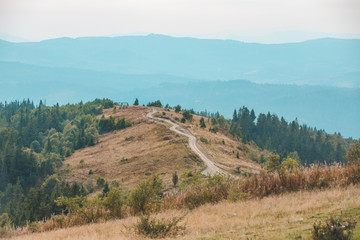 Fototapeta na wymiar trail road in mountains autumn landscape
