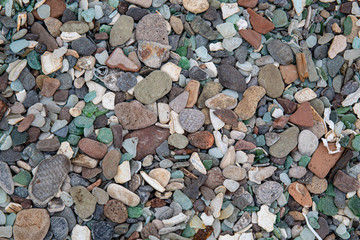 Multicolored colorful sea pebbles, natural background, texture. Close-up texture of colorful sea pebbles. Small Rock. Sea background