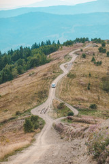 off road car travel by mountains peak autumn season