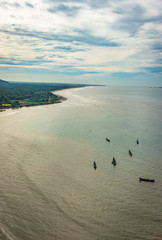 beach isolated with fishing boats aerial shots with dramatic sky