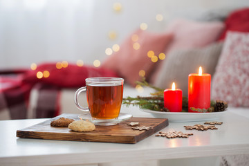 cup of tea with burning candles at home