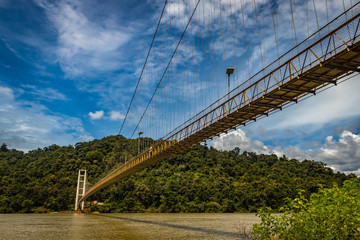 suspension iron bridge isolated with bright blue sky from unique different angle