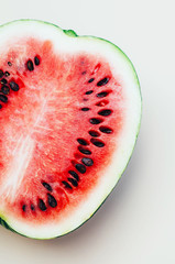 Juicy half of a cut watermelon on a light background.
