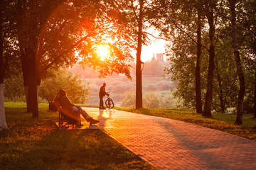 Sunset silhouette of man with bicycle