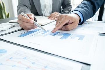 Two business leaders talk about charts, financial graphs showing results are analyzing and calculating planning strategies, business success building processes