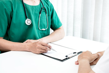 Male doctors explain and recommend treatment after a male patient meets a doctor and receives...