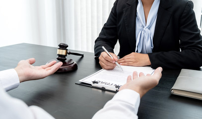 A woman lawyer or a judge counseling clients about judicial justice and prosecution with scales,...