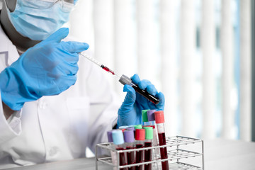 Professional doctors perform find virus tests from samples of blood tests to diagnose coronary...