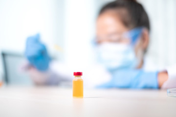 Professional doctors perform testing and analyzing samples of vaccines for immunization prevention and treatment from viral infections. Medical and health care concepts