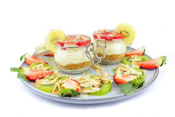 Home made cheese cake with a selection of fruits and strawberry topping.