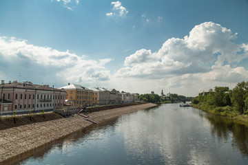 Summer russian river townscape of green embankment