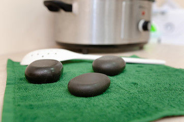 Hot stone massage therapy Close up pile of spa stones with aroma oil still life	
