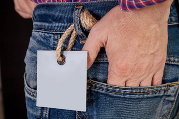 Hand in back pocket of blue jeans close-up