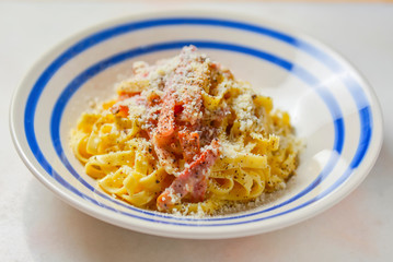Plate of penne pasta with cheese and meat. Healthy and delicious dinner.
