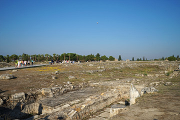 Exterior architecture and ancient design of Hierapolis and Pamukkale national park, town in western Turkey known as mineral-rich thermal waters flowing down white travertine terraces on hillside