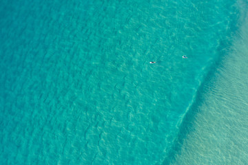 Fototapeta na wymiar Aerial view surfers at Alexandra Bay, Noosa National Park