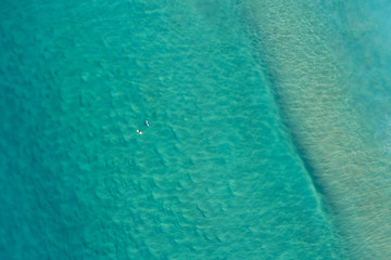 Aerial view surfers at Alexandra Bay, Noosa National Park