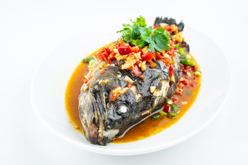 Braised grouper in a dish of Chinese cuisine on white background