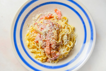 Plate of penne pasta with cheese and meat. Healthy and delicious dinner.